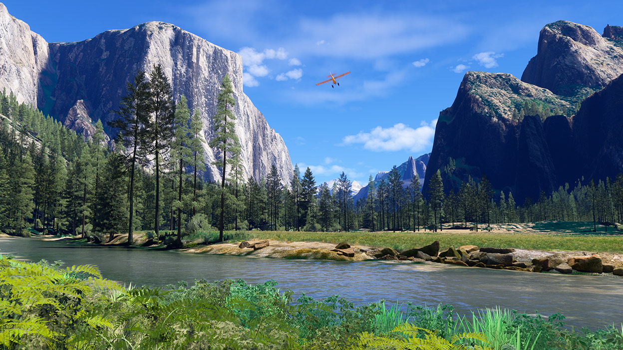 A tiny red plane flying over a beautiful forest surrounded by mountains. 